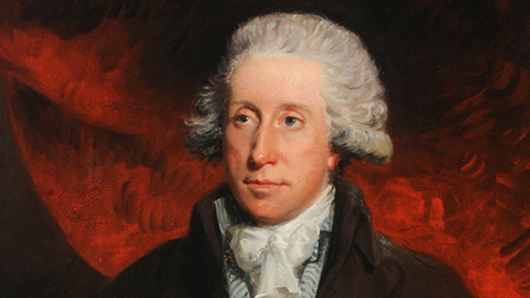 A man's head and shoulders, wearing a white wig and Victorian jacket and necktie, in front of a red background.
