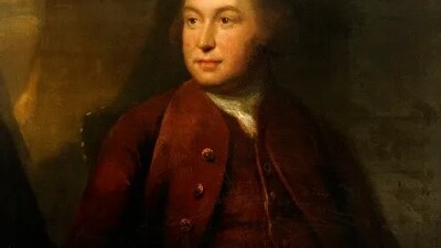 A classical oil painting of a man in 18th-century clothing, seated and gazing slightly to his left. He wears a brown coat and waistcoat with a white shirt, and the background is dark and shadowy.