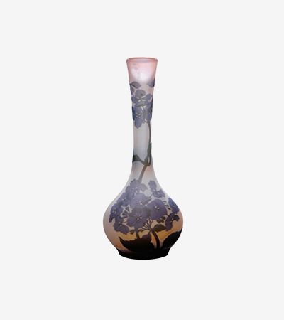 A vase with a long thin neck and short round base with patterns of flowers and leaves in black