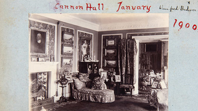 Black and white photograph of the drawing room at Cannon Hall, 1900, with paintings on the walls and a chez longe.