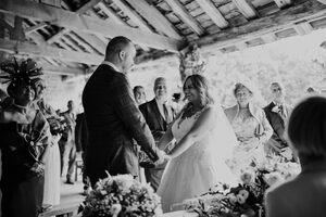 Black and white photo of the bride and groom getting married in the Deer Shelter at Cannon Hall. 