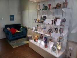 Ceramics Gallery showing ceramic displays and a comfortable sofa with cushions to sit on