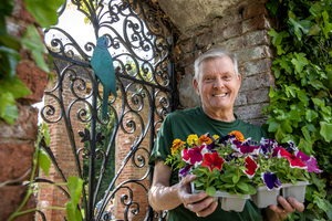 A man holding some flowers.