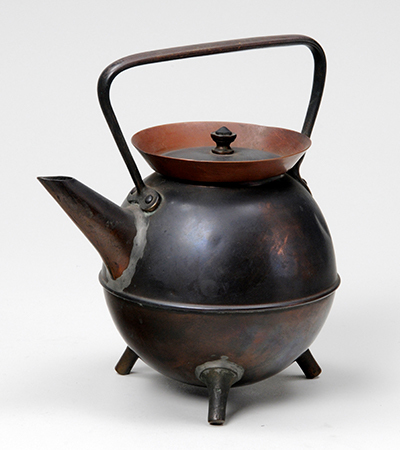 Stout copper kettle with a round body and short spout. It has a handle over the top of its lid