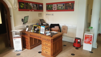 Museum front desk. A wooden oak desk in the reception area.