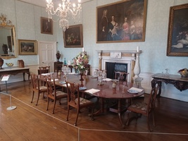 Dining Room showing a grand dining table set for a meal, and artworks on the walls.