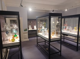 Glass gallery with cases filled with glass ornaments of different colours.