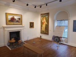 De Morgan Gallery showing art works of female figures by Evelyn De Morgan and a period fireplace